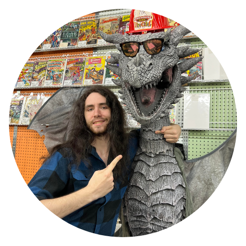 Staff member Nick posed with a dragon statue 