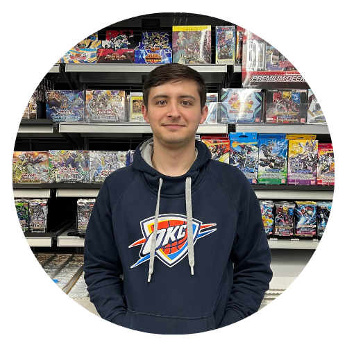 Staff member Jesse, standing in front of trading card games
